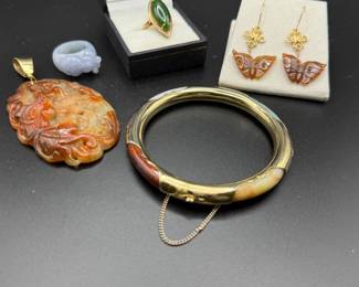 Burmese carved lavender Jadite ring, Victorian green jade ring in 14k gold setting, a red jade dragon pendant with 14k gold bail, red Jadite butterfly earrings by Nikolai Tsang in 14k gold, a multi jade bangle. 