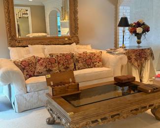 Coffee table, couch with pillows, mirror