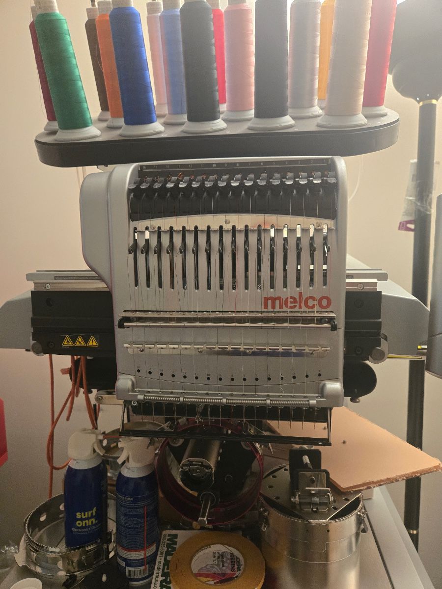 Melco EMT16X, 16-needle embroidery system A commercial-grade multi-needle embroidery machine built for production work. It handles caps, jackets, polos, bags and flat goods, and its 16 needles let you run multi-color designs without stopping to change thread. Accessories included.
