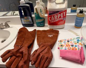 Cleaning supplies with leather work gloves and microfiber cloths