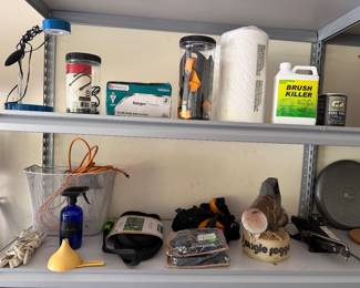 Shelf with brush killer, sprayer and assorted tools