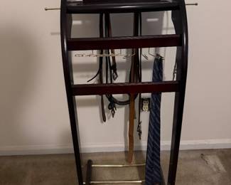 Wooden valet stand hung with neckties and belts