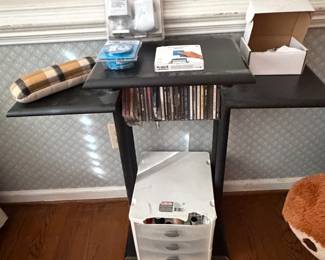 Console table with vinyl record albums and storage bin