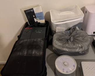 Small electronics and folded bedding on table