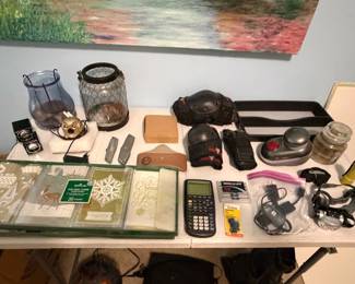 Glassware, leather belts, calculators and desk accessories on table