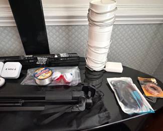 Camera tripod and photography accessories on table