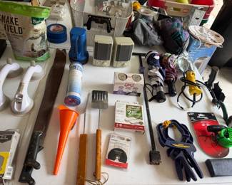Caulk gun, snake repellent, safety glasses and assorted tools