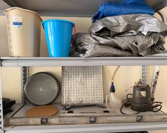 Shelving with tarps, buckets and utility pump