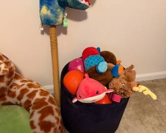 Dinosaur hobby horse and basket of stuffed animals