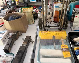 Paint rollers, brushes and levels on work table