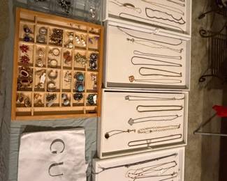 Jewelry display boards with chain necklaces and carded earrings