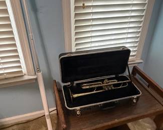Brass trumpet in open case on wood stand