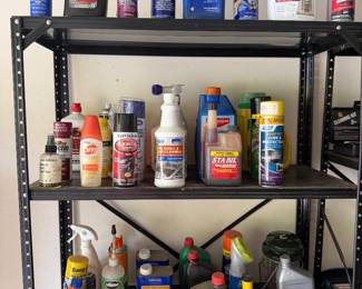 Metal shelving with automotive fluids and garage chemicals
