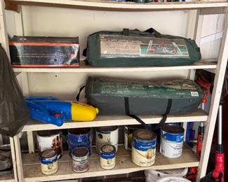 Garage shelving with paint cans and maintenance supplies