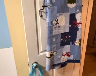 Holiday themed towels and tote bags on door hooks