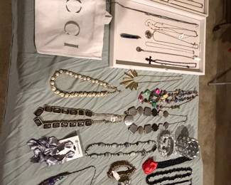Gucci jewelry box with designer necklaces, bracelets and beaded strands