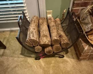 Black metal firewood holder with logs