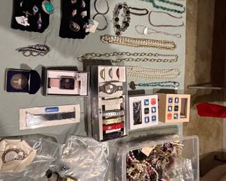 Earring cards, boxed wristwatches, rings and assorted jewelry on display