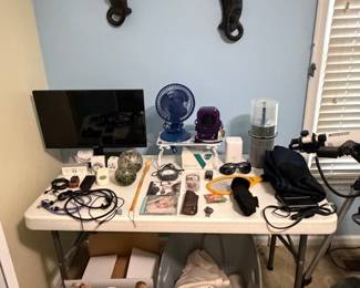 Shelf with small electronics, fan and desk accessories