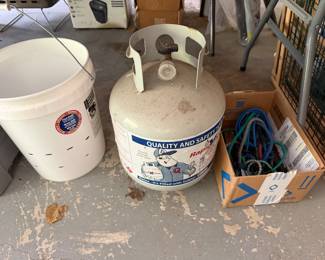 Propane tank, utility buckets and bungee cords