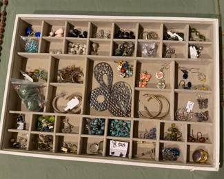 Divided tray of earrings including hoops, studs, turquoise and a filigree heart pendant