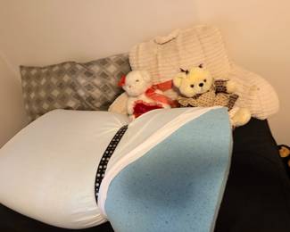 Bed with knit throw, pillows and stuffed animals