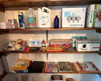 Shelving unit with books, household goods and cleaning supplies