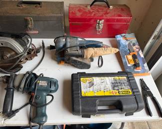 Tool box with corded drills, reciprocating saw and accessories
