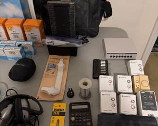 Camera bag, calculator, remotes and small electronics