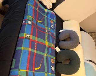 Twin bed with sleeping bag and bedding
