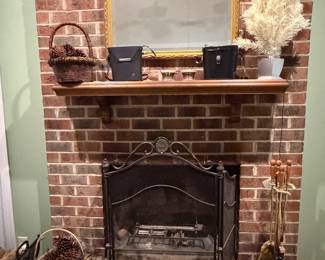Brick fireplace with wood mantel and decorative accents