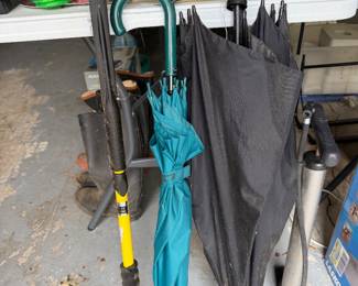 Umbrellas and long handled garden tools