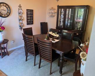 Traditional dark wood dining room suite including an oval table with six slat-back chairs