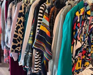 Multiple racks of vintage and contemporary clothes