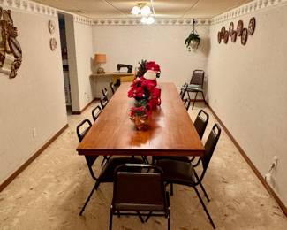 Very long handmade table collapsible with 12 chairs and tableclothes.