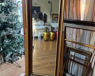 This is a full-length standing mirror, with a tilt feature.  There are empty picture frames next to it.  Surely you have a few pictures or paintings you could put in the frames.  Oh, and look at the image in the mirror: two golden urns or large vases.