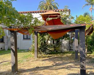 Outside in the back yard we have this fabric picnic shelter.  You might call it a pergola or a canopy tent.  Whatever the exact name, it's available in the sale.