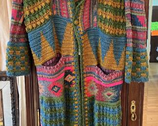 Here we have a long knit coat from Saachi.