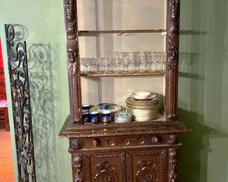 One could argue that the previous display cabinet matches this smaller cabinet, at least in the general sense.  Don't miss the gold-rimmed stemware on the middle shelf.