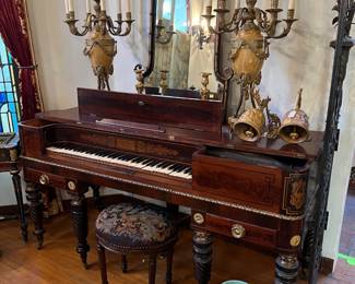 It is tricky to see in the photo, but this appears to be a Jacobs Brothers parlor square piano.  The candelabras and mirror seem to fit the style fairly well.  Maybe buy all three?