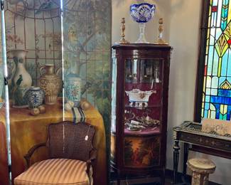 In this photo, you can see two panels of a painted folding screen, a cushioned chair, a small display case, and more.