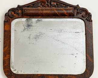 Antique carved dark wood wall mirror.