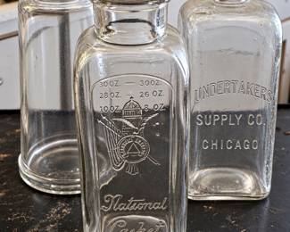 National Casket Co. and Undertakers Supply Co., Chicago glass bottles and a glass funnel