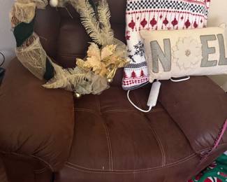 Leather upholstered seating with decorative pillows and seasonal accents | Wildflower Lane Estate Sales | Sugar Land, TX
