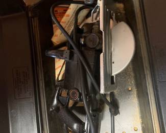 Vintage Craftsman circular saw stored inside a molded plastic carrying case alongside original paperwork.