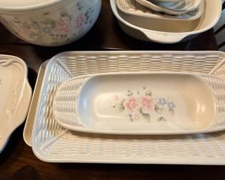 Collection of Pfaltzgraff Tea Rose pattern ceramic serving pieces, including basketweave-style platters, baking dishes, and bowls.