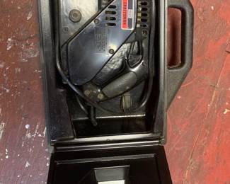 Sears Craftsman electric belt sander stored inside its original black molded plastic carrying case.