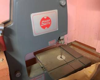 Vintage Shopsmith band saw attachment in grey casing, showing light dust and wear from use.
