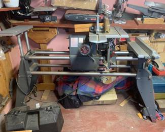 Vintage Shopsmith Mark V multi-purpose woodworking machine with attached saw table and auxiliary work surfaces.