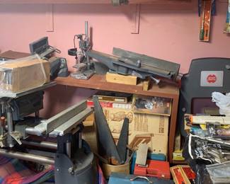 Workshop corner featuring a Shopsmith multi-purpose woodworking machine, benchtop jointer, drill press stand, metal toolboxes, and assorted vintage hand tools.